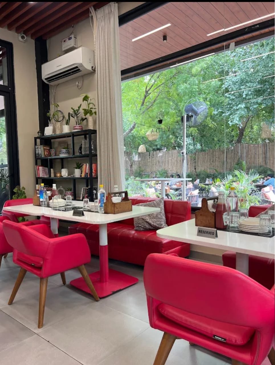 VEDA Cafe cosy indoor seating with red chairs